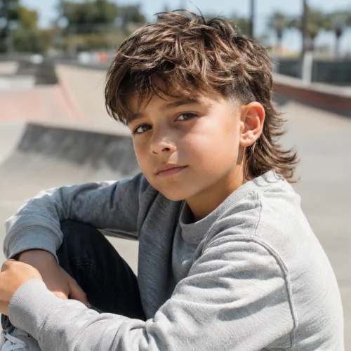 kids Textured mullet haircut with choppy layers and added hair dimension
